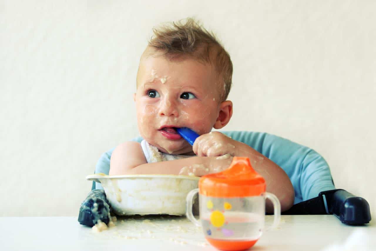 Toddler eating oatmeal