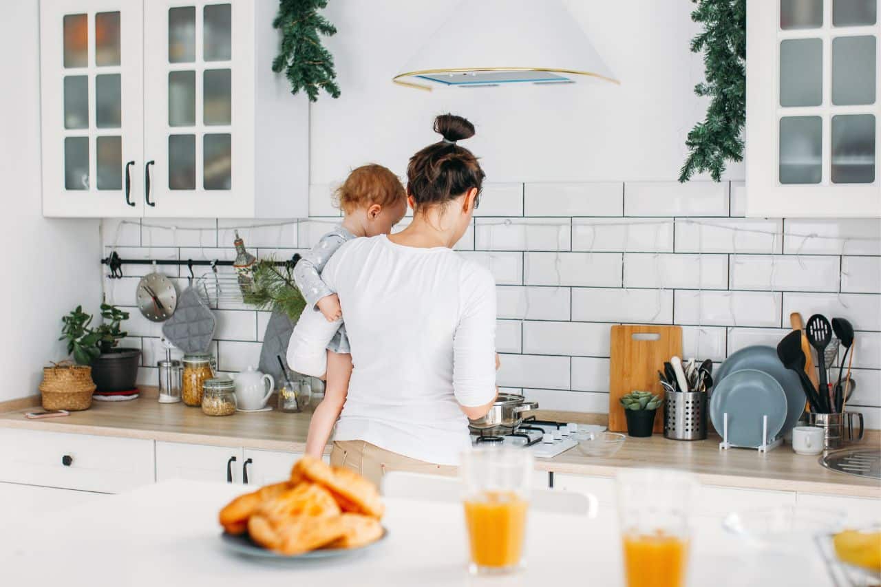 Mom cooking breakfast for toddler